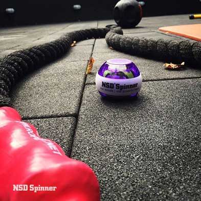 Purple NSD Spinner on a gym floor next to battle ropes