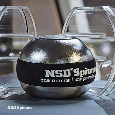 Silver NSD Spinner with a clear base on a desk