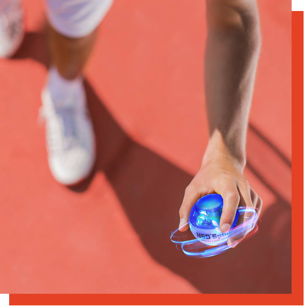 Tennis player holding a spinning NSD Spinner on a tennis court