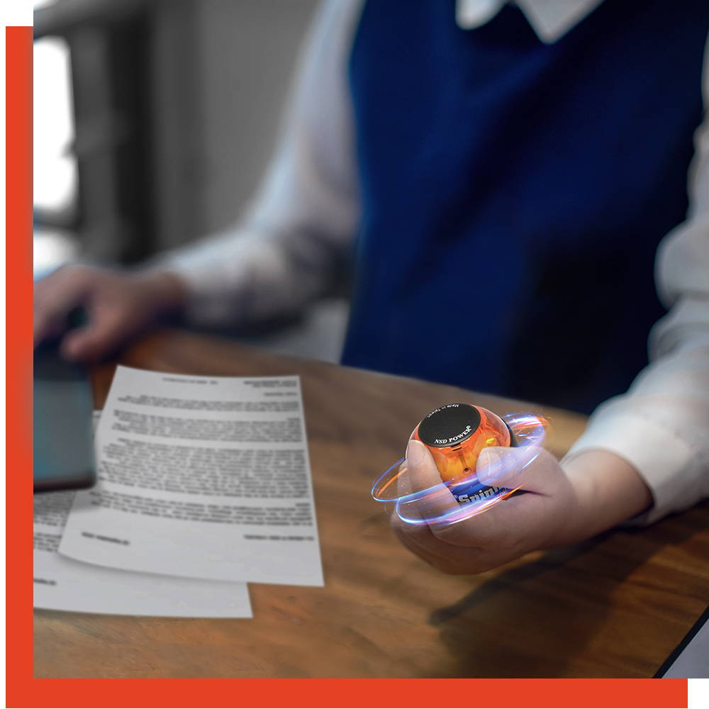 Office worker spinning an NSD Spinner at his desk