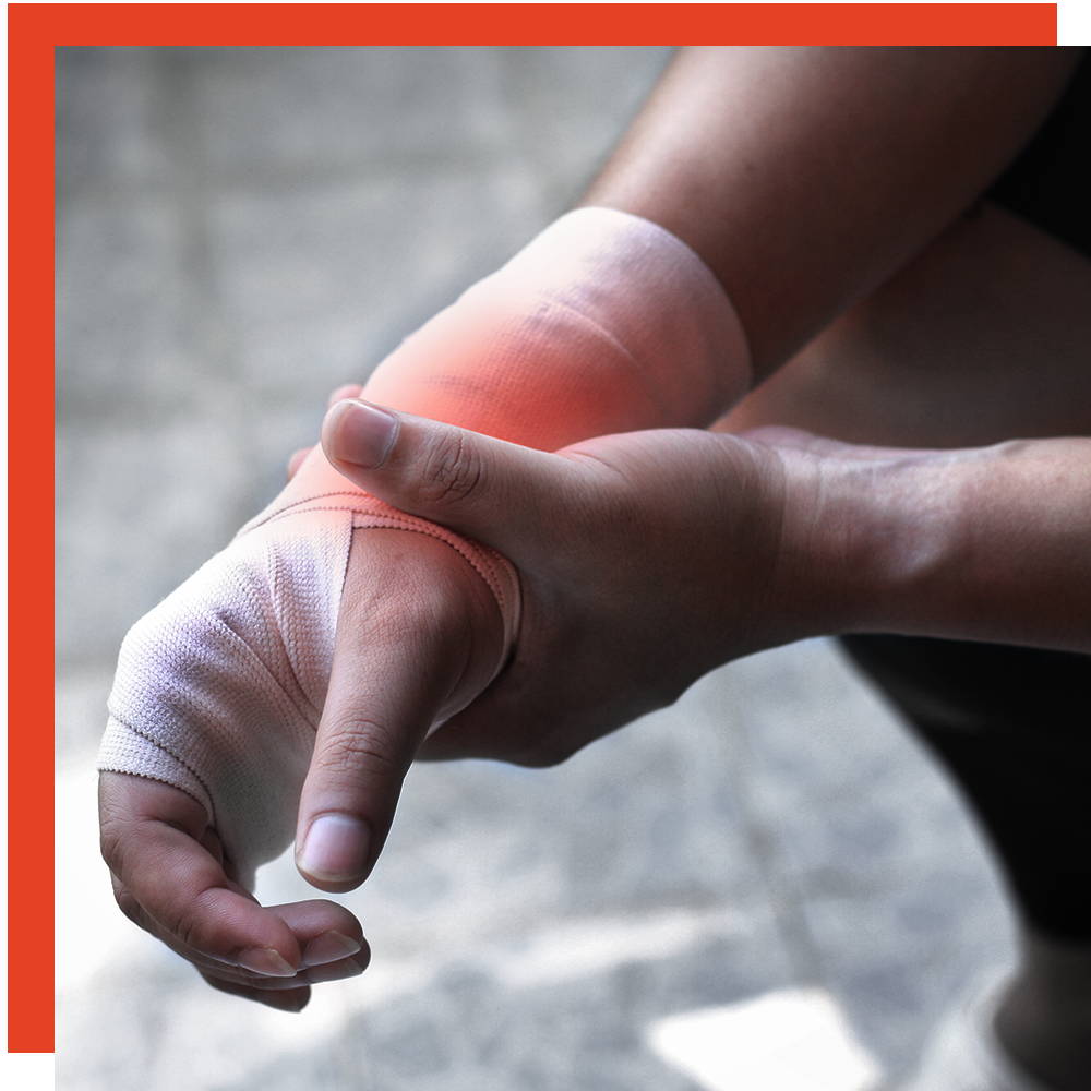 Person with a bandaged hand holding an inflamed, painful wrist